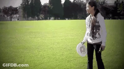 Woman Holding Frisbee In Field GIF