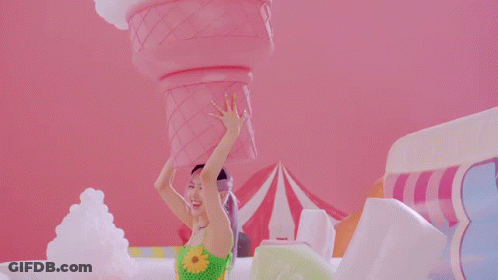 Woman Holding Giant Pink Ice Cream Cone On Head GIF