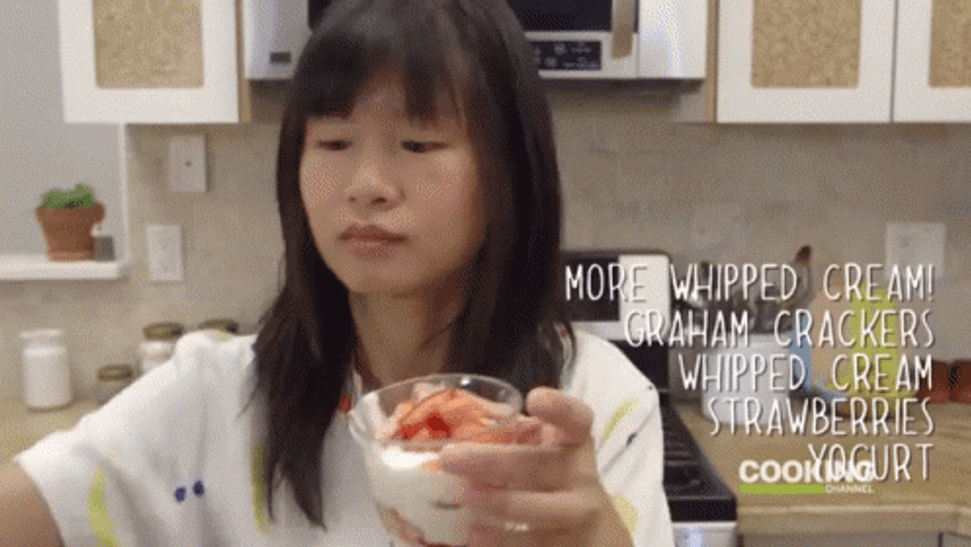 Woman Holding Glass Containing Berries And Cream GIF