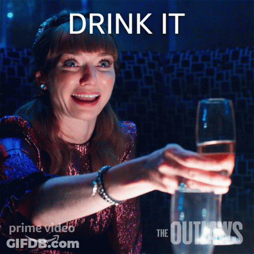 Woman Holding Glass Of Wine In Front Of Drink It Sign GIF