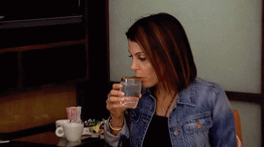 Woman Holding Glass Shivering GIF