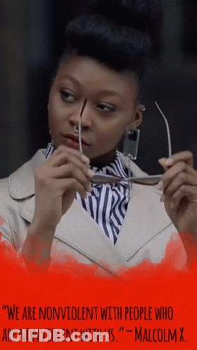 Woman Holding Glasses With Malcolm X Quote GIF
