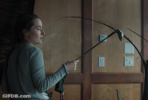 Woman Holding Golf Club In Front Of Thermostat Saying A GIF