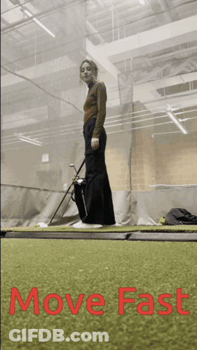 Woman Holding Golf Club In Gym GIF
