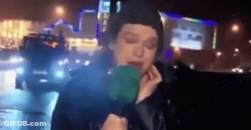 Woman Holding Green Object In Front Of Face GIF