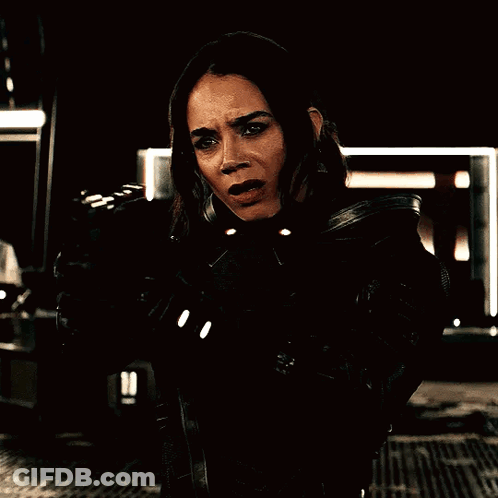Woman Holding Gun In Dark Room GIF