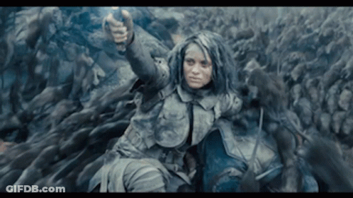 Woman Holding Gun In Front Of Crowd GIF