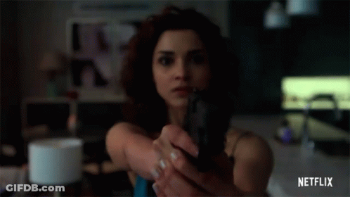 Woman Holding Gun In Front Of Face GIF