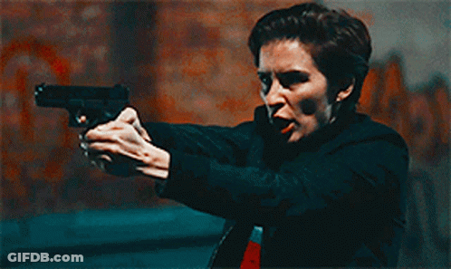 Woman Holding Gun Pointing At Camera GIF