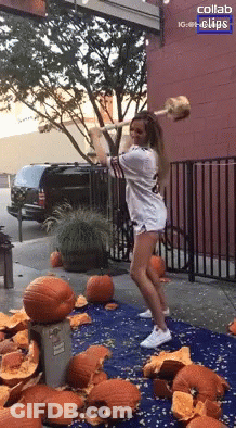 Woman Holding Hammer Near Pumpkins And Collab Sign GIF