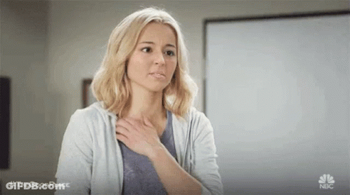 Woman Holding Hand To Chest GIF