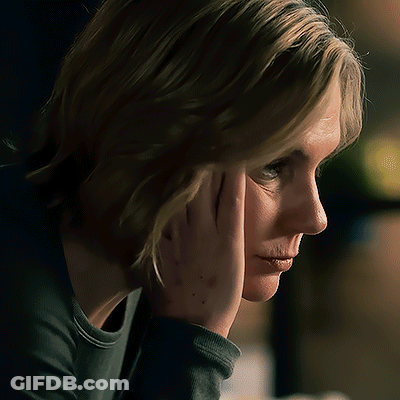 Woman Holding Hand To Face Looking Down GIF