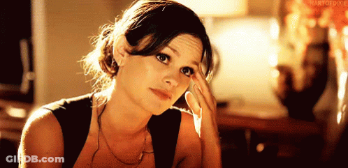 Woman Holding Hand To Forehead In Black Tank Top GIF