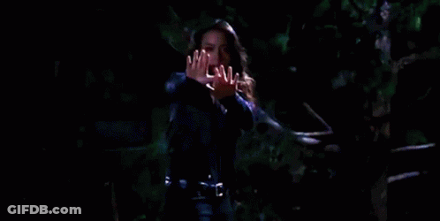 Woman Holding Hands Up In Darkness GIF
