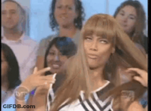 Woman Holding Her Hair In Front Of Crowd GIF