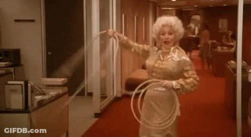 Woman Holding Hula Hoop In Hallway GIF