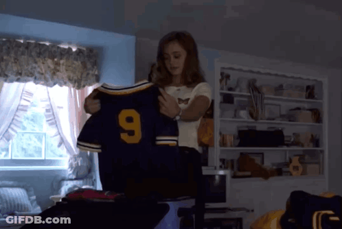 Woman Holding Jersey Number 9 GIF