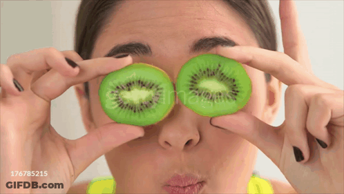 Woman Holding Kiwi Slices GIF