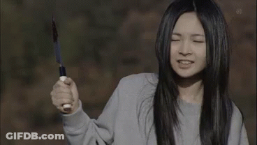 Woman Holding Knife Making Face GIF