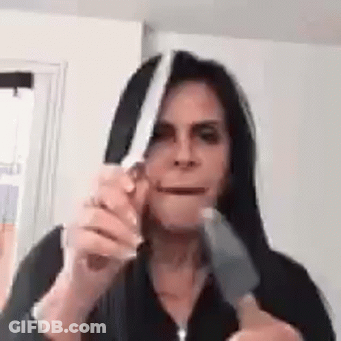 Woman Holding Knife Near Mouth GIF