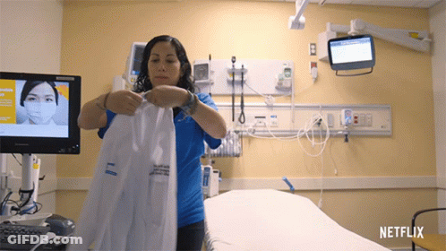 Woman Holding Lab Coat In Hospital Room With Netflix GIF