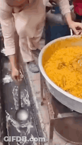 Woman Holding Ladle Over Food GIF