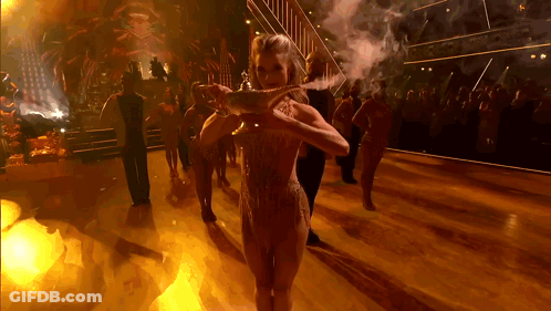 Woman Holding Lamp On Dance Floor GIF
