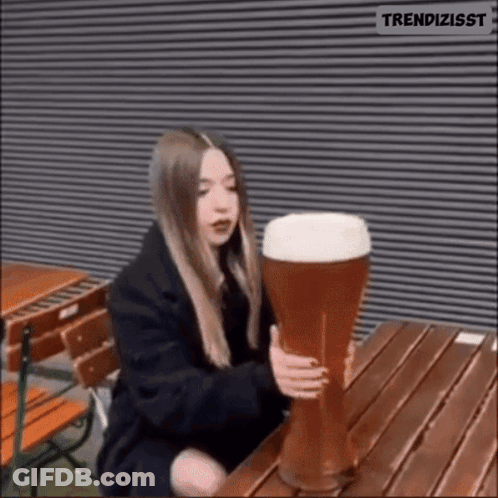 Woman Holding Large Glass Of Beer GIF