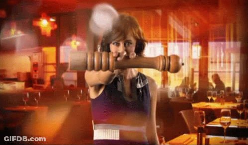 Woman Holding Large Pepper Mill GIF