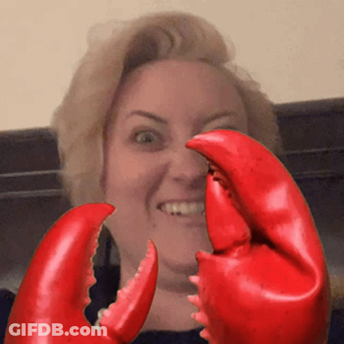 Woman Holding Large Red Lobster Claws In Front Of Face GIF
