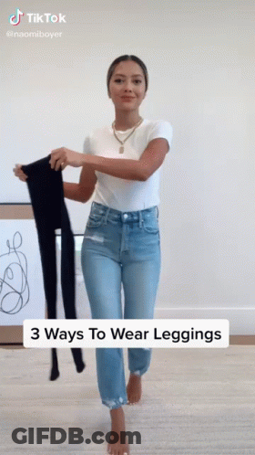 Woman Holding Leggings In Jeans And White Shirt GIF