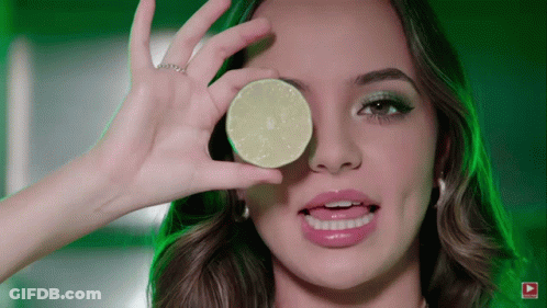 Woman Holding Lime Slice Over Eye GIF