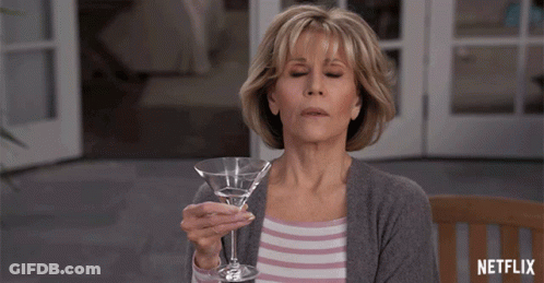 Woman Holding Martini Glass With Netflix Logo GIF