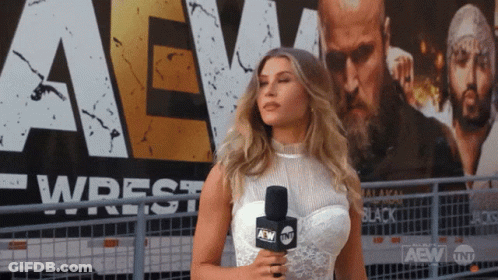 Woman Holding Microphone In Front Of AEW Sign GIF