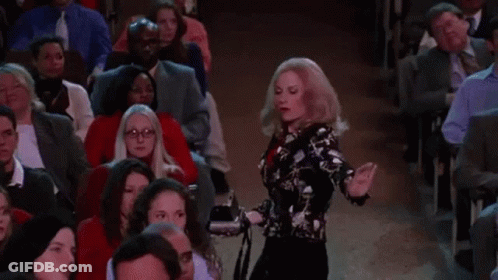 Woman Holding Microphone In Front Of Crowd GIF