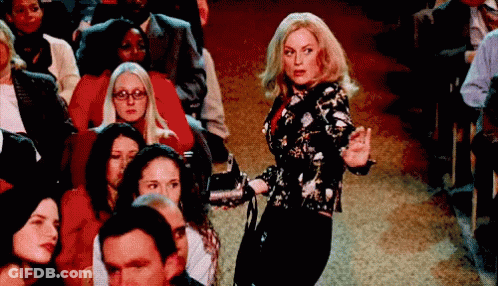 Woman Holding Microphone In Front Of Crowd GIF