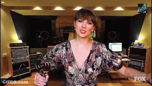 Woman Holding Microphone In Front Of Fox Sign GIF