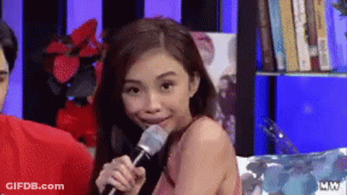 Woman Holding Microphone In Mouth Smiling GIF