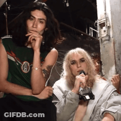 Woman Holding Microphone Next To Man In Green Shirt GIF