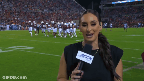 Woman Holding Microphone With 'Accn' Written On It GIF