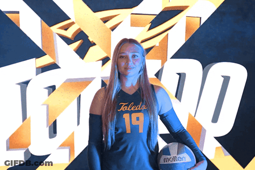 Woman Holding Molten Volleyball In Front Of Toledo Logo GIF