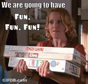Woman Holding Monopoly And Clue Board Games GIF