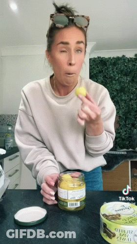 Woman Holding Mustard Jar And Oyster Can GIF