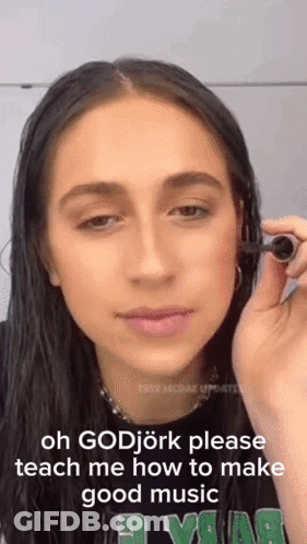 Woman Holding Object Saying Oh Godjork Please Teach Me How To Make Good Music GIF