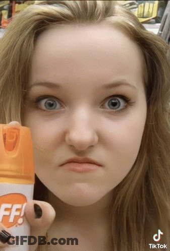 Woman Holding Off Bug Spray GIF