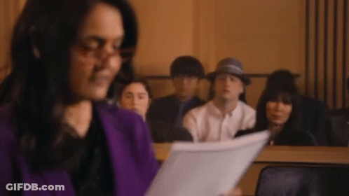 Woman Holding Paper In Front Of Group GIF
