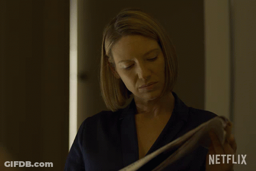 Woman Holding Paper With Netflix Logo GIF