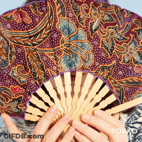 Woman Holding Patterned Fan GIF