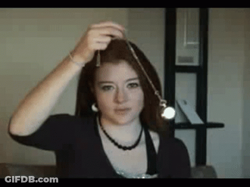 Woman Holding Pendulum With Necklace GIF