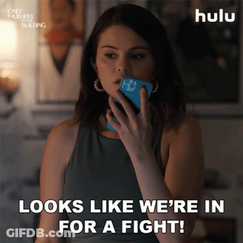 Woman Holding Phone Saying Looks Like We're In For A Fight GIF